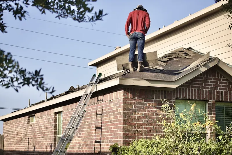Professional roofer working on a residential roof in Meacham
